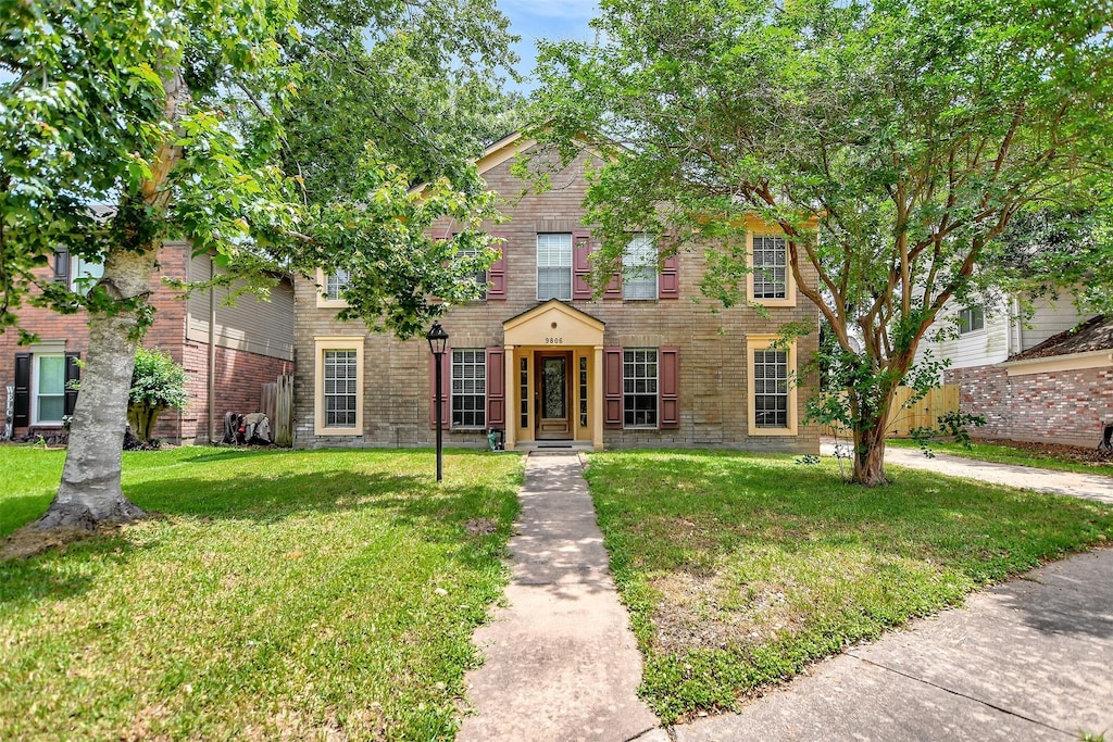 9806 Arrowgrass Dr, Houston, TX 77064 - colonial home with brick siding and a front yard