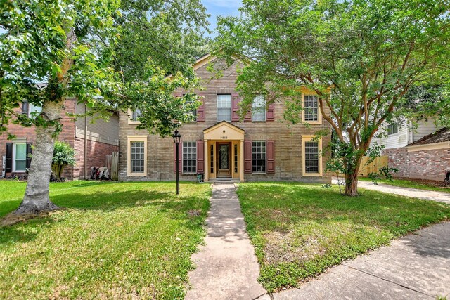 9806 Arrowgrass Dr, Houston, TX 77064 - colonial home with brick siding and a front yard