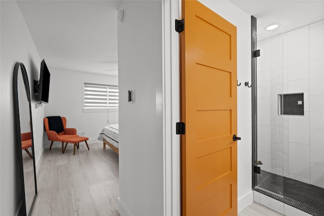 604 Calico Jack Cv, Galveston, TX 77554 - ensuite bathroom with ensuite bathroom, a stall shower, baseboards, recessed lighting, and wood finished floors