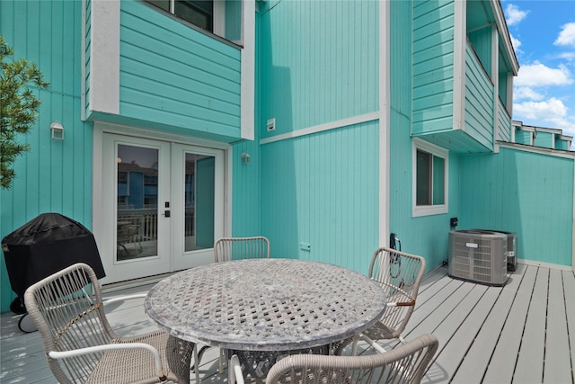 604 Calico Jack Cv, Galveston, TX 77554 - deck with grilling area, central AC, french doors, and outdoor dining area