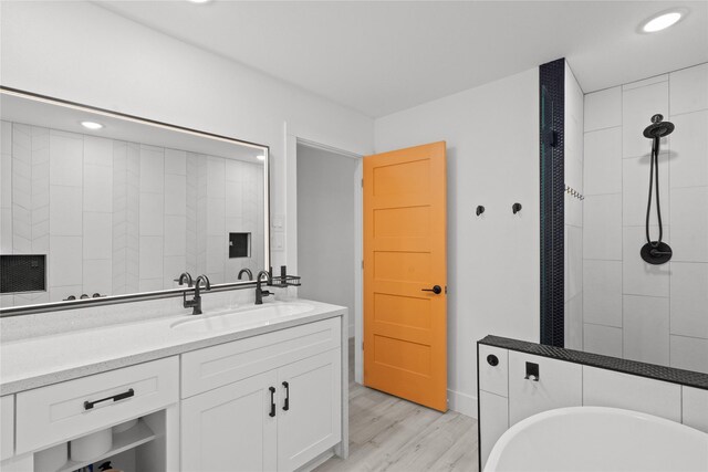 604 Calico Jack Cv, Galveston, TX 77554 - full bathroom with recessed lighting, tiled shower, vanity, a freestanding bath, and wood finished floors