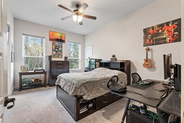 1406 Amber Cv, Willis, TX 77378 - bedroom with light carpet, an office area, and a ceiling fan