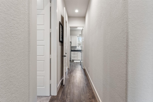 1406 Amber Cv, Willis, TX 77378 - hall featuring a textured wall, dark wood-style floors, baseboards, and recessed lighting