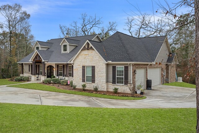 1406 Amber Cv, Willis, TX 77378 - view of front of property with stone siding, concrete driveway, a shingled roof, a front lawn, and a porch
