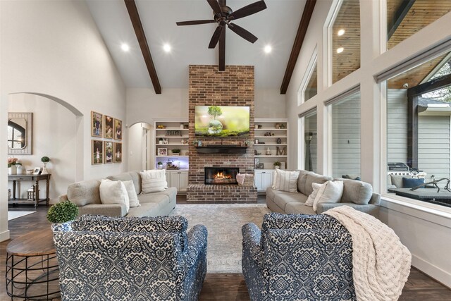 1406 Amber Cv, Willis, TX 77378 - living area featuring ceiling fan, dark wood finished floors, arched walkways, beam ceiling, and baseboards