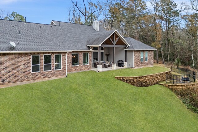 1406 Amber Cv, Willis, TX 77378 - rear view of property featuring a chimney, roof with shingles, brick siding, and a patio area