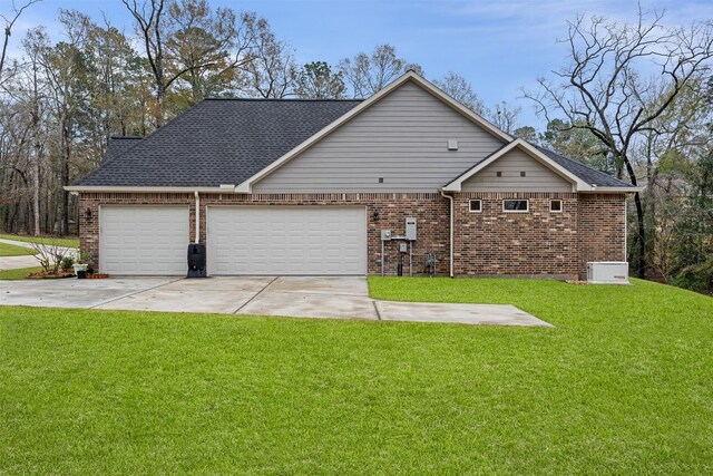 1406 Amber Cv, Willis, TX 77378 - view of property exterior featuring brick siding, an attached garage, driveway, and a lawn
