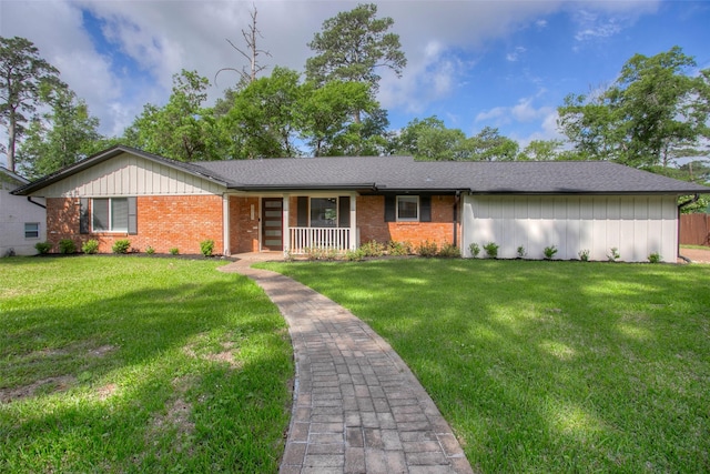 ranch-style house featuring covered porch, a front lawn, and brick siding