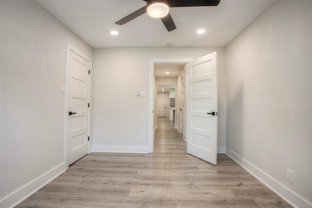 unfurnished bedroom featuring baseboards, light wood-style floors, and recessed lighting