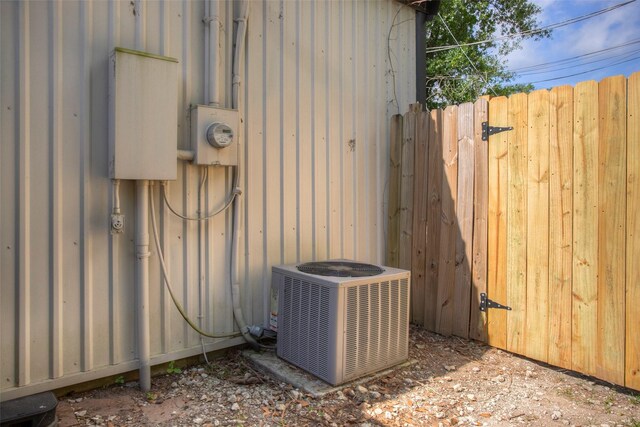 details with central AC unit, fence, and electric meter