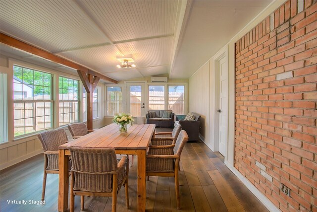 sunroom featuring an outdoor hangout area, a wealth of natural light, and a wall unit AC