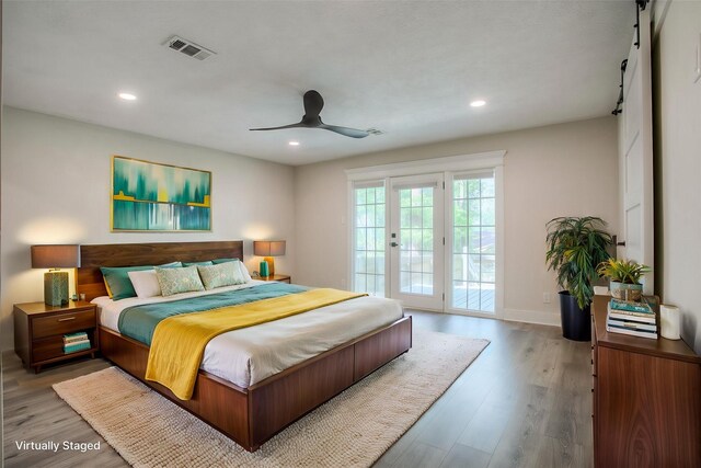 bedroom featuring wood finished floors, visible vents, access to outside, and recessed lighting