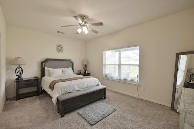 bedroom featuring carpet floors, a ceiling fan, visible vents, and baseboards
