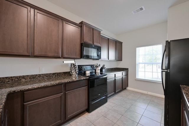 kitchen featuring visible vents, light tile patterned floors, baseboards, dark brown cabinetry, and black appliances