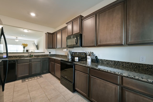 kitchen with a sink, light tile patterned flooring, dark brown cabinetry, ceiling fan, and black appliances