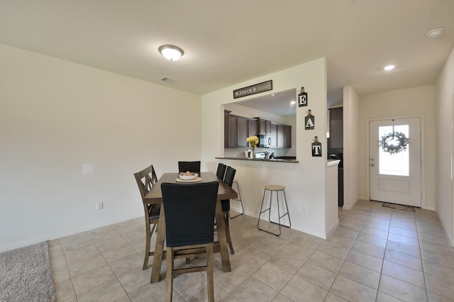 dining space with visible vents and light tile patterned floors