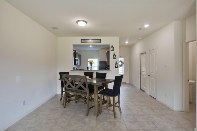 dining room featuring baseboards, visible vents, recessed lighting, and light tile patterned floors