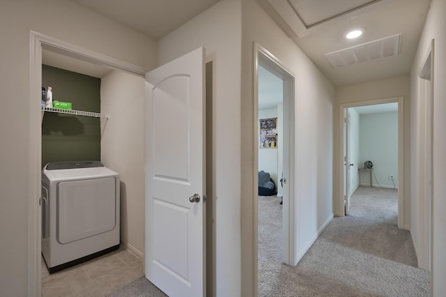 hallway with recessed lighting, visible vents, light carpet, baseboards, and washer / clothes dryer