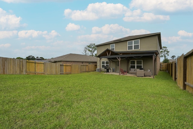 rear view of property with a yard, an outdoor hangout area, a patio area, and a fenced backyard