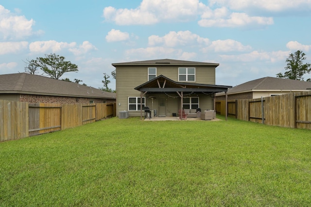 rear view of house with a lawn, a fenced backyard, a patio, and an outdoor living space