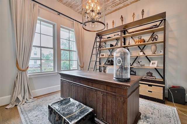 office with baseboards, wood ceiling, a chandelier, and wood finished floors