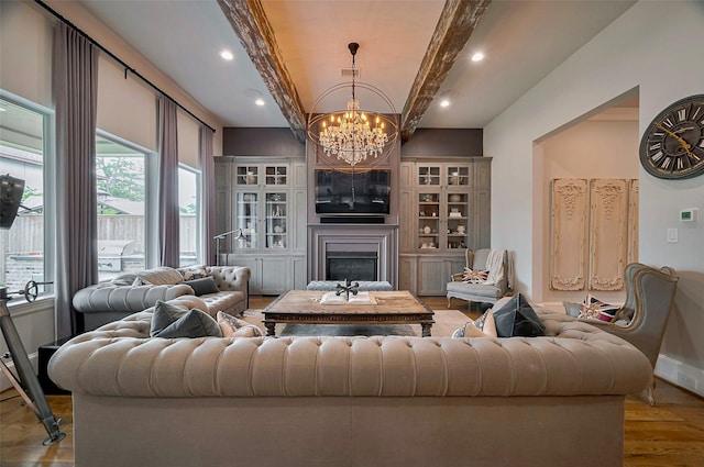 living area with a chandelier, wood finished floors, a fireplace, beam ceiling, and recessed lighting