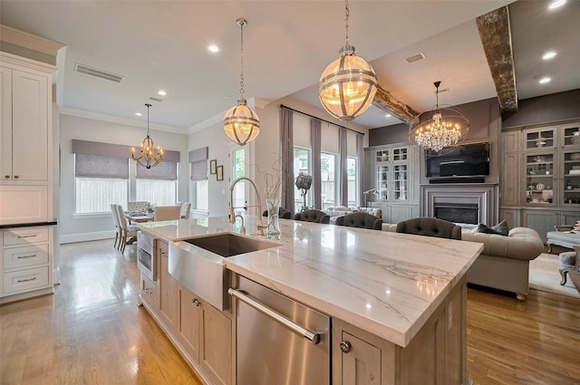 kitchen with a chandelier, appliances with stainless steel finishes, a sink, open floor plan, and recessed lighting