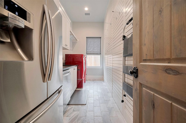 clothes washing area featuring baseboards and recessed lighting