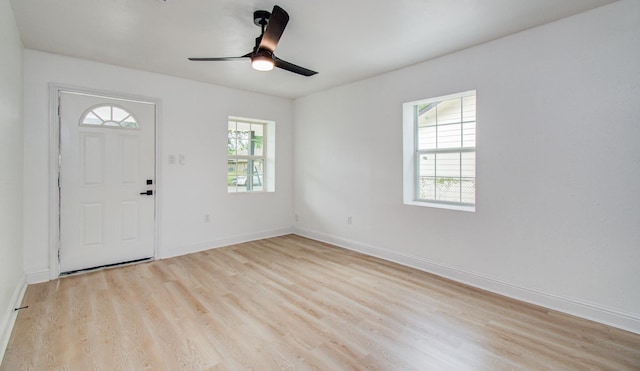 entrance foyer featuring light wood-type flooring, a ceiling fan, and baseboards