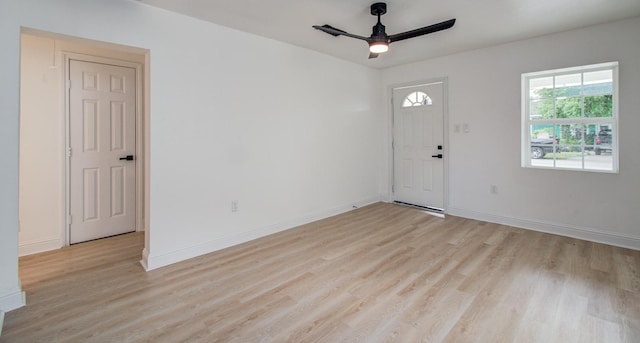 foyer with baseboards, a ceiling fan, and light wood finished floors