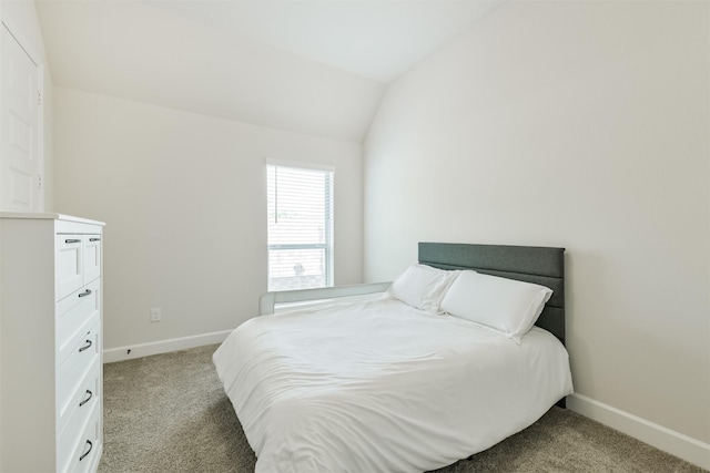 bedroom featuring carpet, lofted ceiling, and baseboards