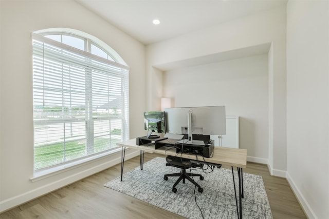 home office featuring baseboards and wood finished floors