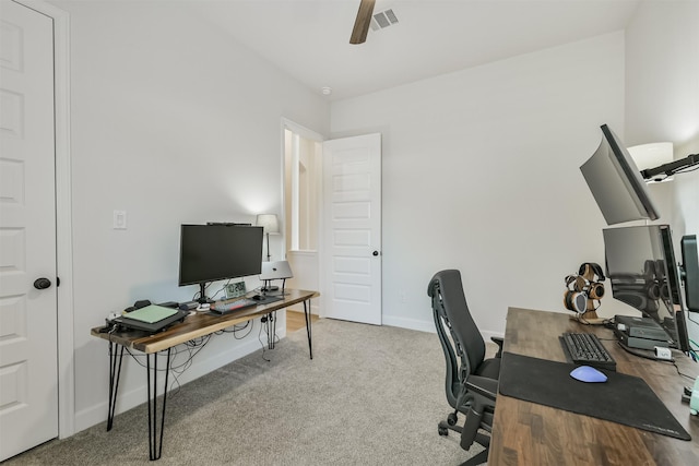carpeted office with baseboards, visible vents, and ceiling fan