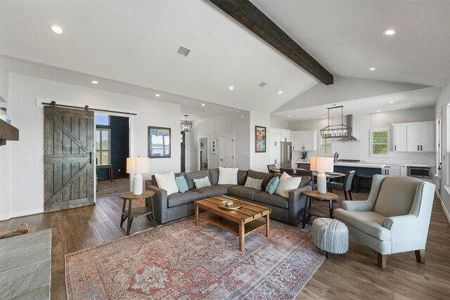 254 Peninsula Dr, Livingston, TX 77351 - living room with beam ceiling, a barn door, visible vents, recessed lighting, and wood finished floors