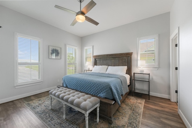 254 Peninsula Dr, Livingston, TX 77351 - bedroom with dark wood-style flooring, a ceiling fan, baseboards, and multiple windows