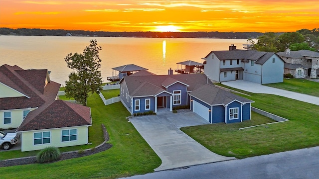 254 Peninsula Dr, Livingston, TX 77351 - view of front of home featuring a front lawn, a residential view, a water view, an attached garage, and driveway