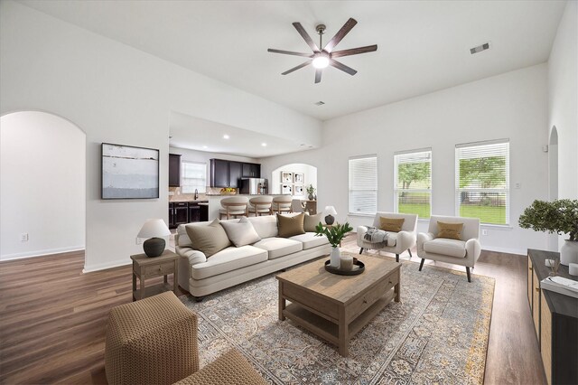 22702 Crate Falls Dr, Hockley, TX 77447 - living room with visible vents, a ceiling fan, wood finished floors, arched walkways, and a wealth of natural light