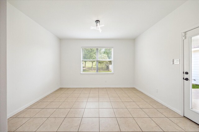 22702 Crate Falls Dr, Hockley, TX 77447 - empty room featuring baseboards and light tile patterned floors