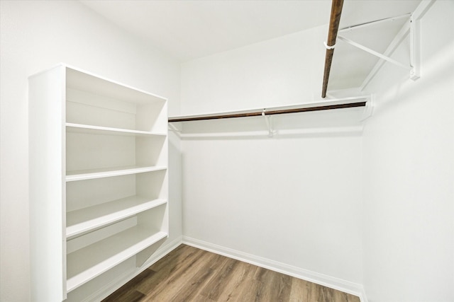 22702 Crate Falls Dr, Hockley, TX 77447 - walk in closet featuring wood finished floors