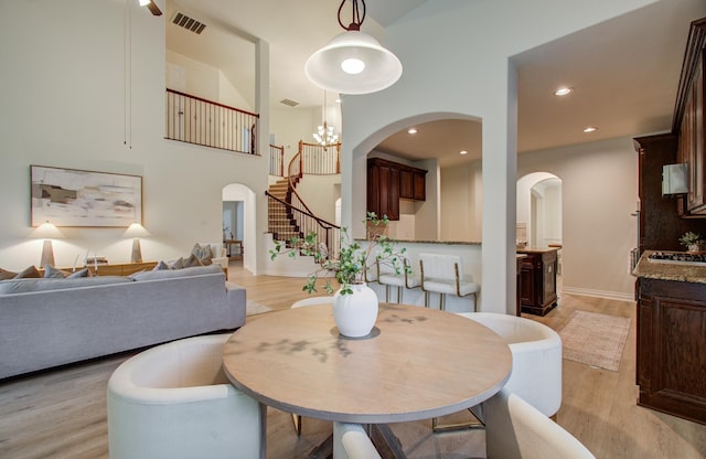 1840 Leela Springs Dr, Conroe, TX 77304 - dining area with arched walkways, light wood-style floors, and visible vents