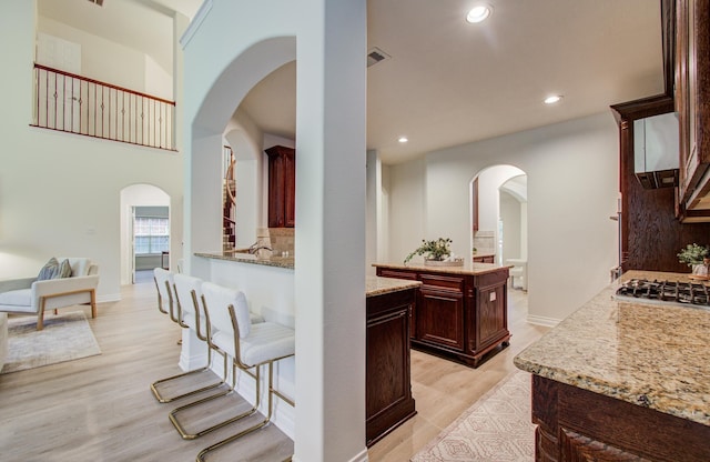 1840 Leela Springs Dr, Conroe, TX 77304 - hall featuring arched walkways, light wood-type flooring, baseboards, visible vents, and recessed lighting