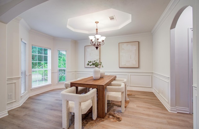 1840 Leela Springs Dr, Conroe, TX 77304 - dining area featuring light wood finished floors, visible vents, an inviting chandelier, and a tray ceiling