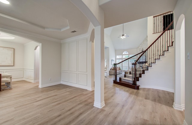 1840 Leela Springs Dr, Conroe, TX 77304 - foyer entrance with arched walkways, a ceiling fan, light wood-style floors, and visible vents