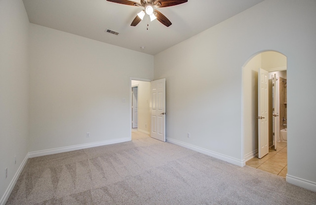 1840 Leela Springs Dr, Conroe, TX 77304 - unfurnished room with arched walkways, baseboards, visible vents, light colored carpet, and ceiling fan