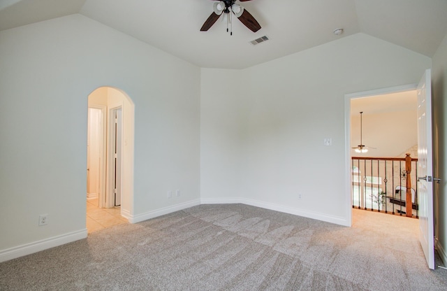 1840 Leela Springs Dr, Conroe, TX 77304 - empty room featuring arched walkways, ceiling fan, vaulted ceiling, and carpet flooring