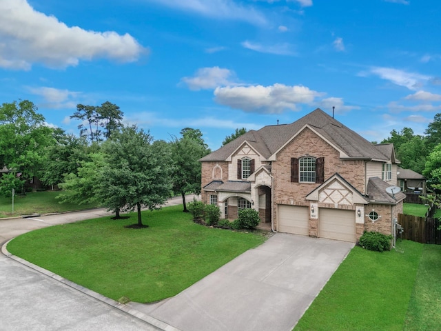 1840 Leela Springs Dr, Conroe, TX 77304 - view of front of property with driveway, fence, brick siding, a garage, and a front yard