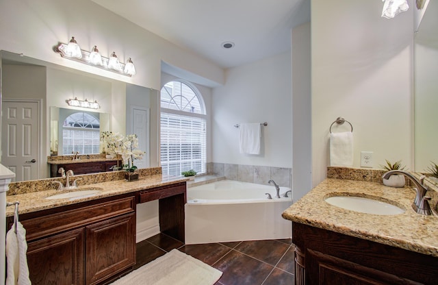 1840 Leela Springs Dr, Conroe, TX 77304 - bathroom featuring two vanities, tile patterned floors, a bath, and a sink