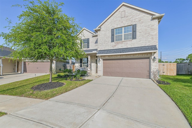 traditional home featuring fence, concrete driveway, brick siding, a front yard, and a garage