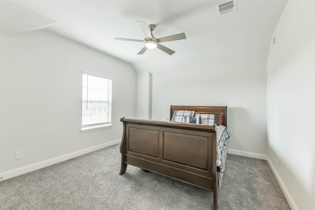 bedroom featuring baseboards, vaulted ceiling, visible vents, and carpet