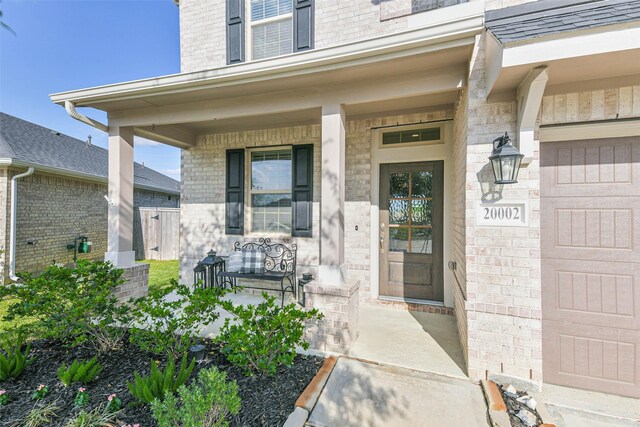 20002 Roan Ardennes Ln, Tomball, TX 77377 - entrance to property featuring covered porch and brick siding